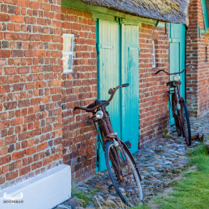 10398 - Old bicycles on farmhouse