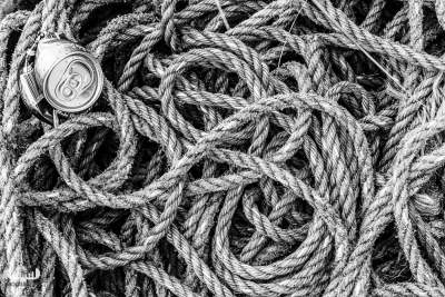 10689 - Ropes and beer can at Nr.Lyngvig Havn in B/W
