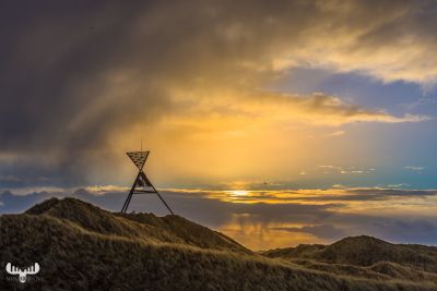 11069 - Husby Klit Båke navigation mark on a stormy sunrise