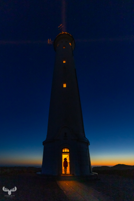 11226 - Nr.Lyngvig Fyr lighthouse at night with lights and person