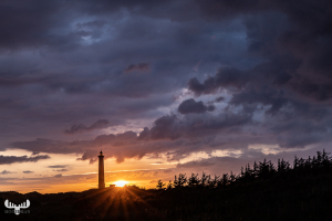 11398 - Nr.Lyngvig Fyr lighthouse with dramatic cloud sky at sun