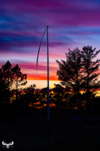 12046 - Flag pole in colorful sunset sky