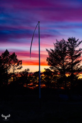12046 - Flag pole in colorful sunset sky