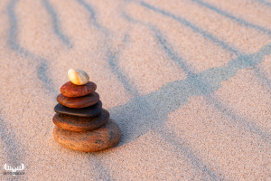 12225 - Pebble tower on sand structures with shadow I