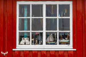 12728 - Window of a red fisherman's hut and Ringkøbing Havn har