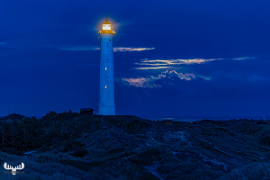 12794 - Nr.Lyngvig Fyr lighthouse at night with moon shining thr