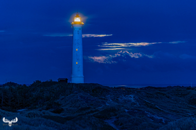 12794 - Nr.Lyngvig Fyr lighthouse at night with moon shining through clouds