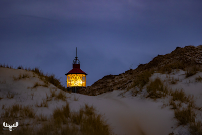 12897 - Nr.Lyngvig Fyr lighthouse with light on peaking between dunes