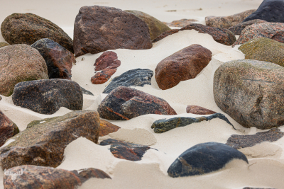 12919 - Pebbles in sand at Skallingen beach