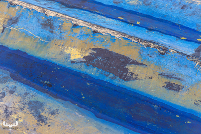 12964 - Waethered paint structures on small rowing boat - detail