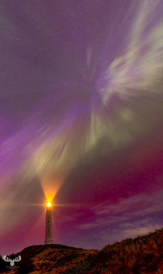 12987 - Nr.Lyngvig Fyr lighthouse radiating into Northern lights sky
