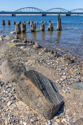 13024 - Oddesundbroen bridge, beach and wood poles in Limfjord