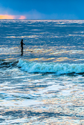 13575 - SUP Stand up paddler oat sunset on Hvide Sande North sea coast with waves