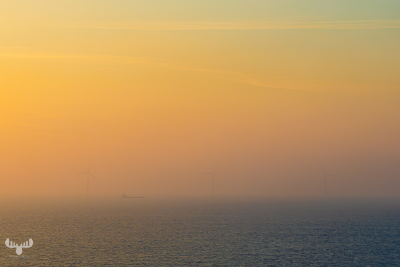 13644 - Faint view on wind turbines and ship over foggy North sea sunset