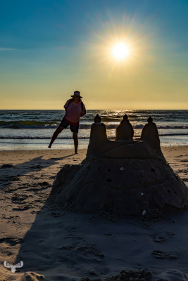 14624 - Sandcastle at North Sea beach at sunset with person