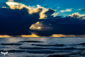 13547 - Amazing and dramatic sunset sky in Hvide Sande at North Sea with fishing boat