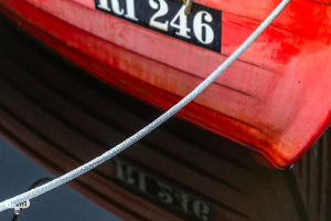14132 - Red fishing boat detail with rope at Stauning Havn harbour