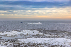 13327 - Ringkøbing Fjord in winter with ice piled up and blue kayak