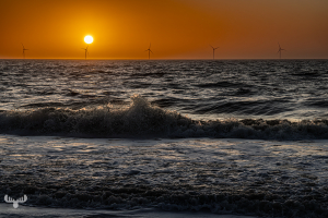 14358 - North Sea sunset with waves and wind turbines