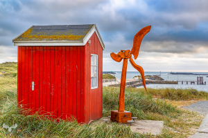 14514 - Red hut with wind turbine model in Hvide Sande harbor
