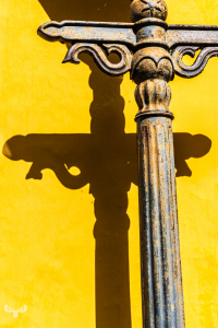 14587 - Lantern pole with shadow on yellow wall