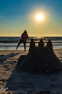 14624 - Sandcastle at North Sea beach at sunset with person