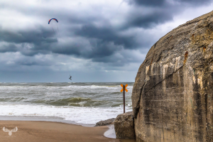 14655 - Flying kitesurfer on North Sea beach with bunker