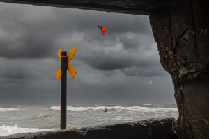 14660 - Kitesurfer on North Sea beach, view through bunker
